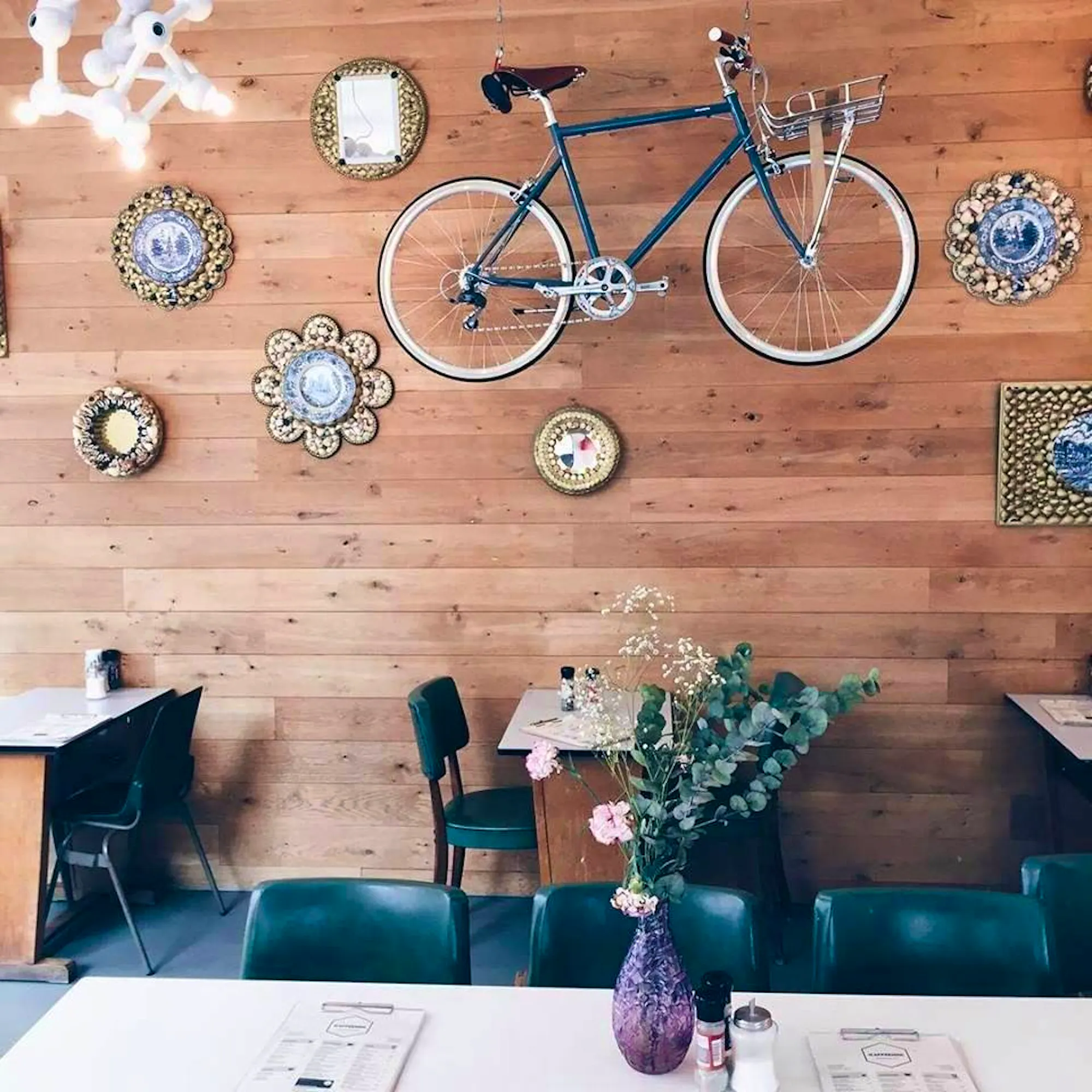 A loaded bagel served on a plate at Kaffeenini